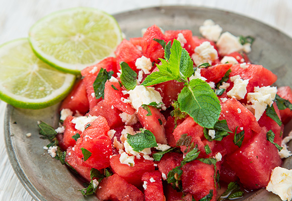 fresh watermelon salad with feta cheese lime slices and mint leaves 15 refreshing summer recipes