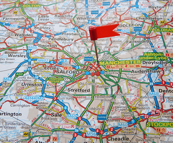 map of Manchester with a red pushpin marking Salford location featuring major roads and landmarks important for navigation 11 routes 11 destinations 11 connections